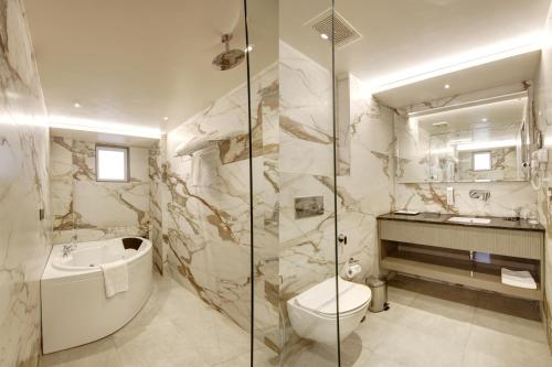 a bathroom with a toilet and a sink at Stepstones Hotels and Inn-DLF PHASE 3 GURGAON in Gurgaon