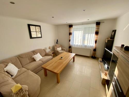 a living room with a couch and a coffee table at Netti Ferienhaus in Marcali