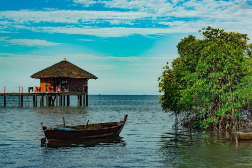 a boat sitting in the water next to a pier at LooLa Adventure Resort in Telukbakau