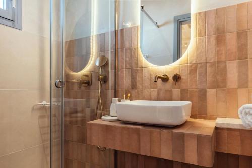 a bathroom with a sink and a shower at Salty Angel Sea Front Villa in Laganas