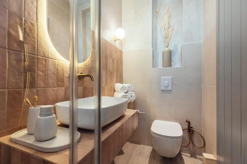 a bathroom with a sink and a toilet at Salty Angel Sea Front Villa in Laganas