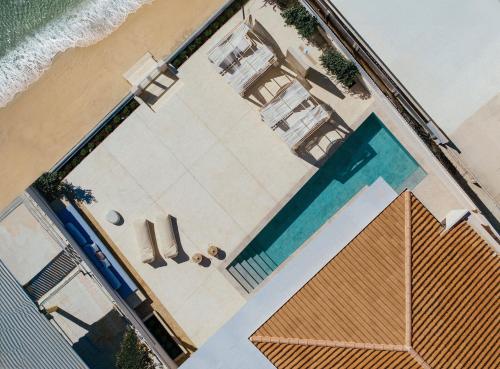 an overhead view of a swimming pool and the beach at Salty Angel Sea Front Villa in Laganas