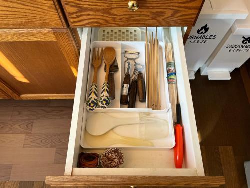 a drawer in a cabinet filled with cooking utensils at Yatsugatake Angel - Vacation STAY 75481v in Hokuto