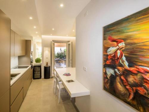a kitchen with a large painting on the wall at CeO LUXURY SUITE DI CAGLIARI in Cagliari