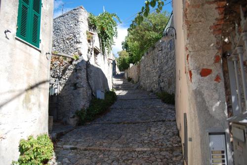 an alley in a village with stone walls at Ca' d'Alda in Borgio Verezzi