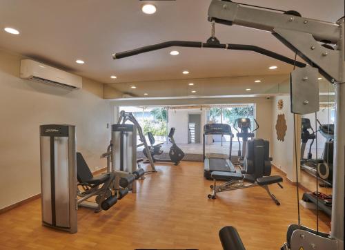 a gym with several tread machines in a room at Hotel Residency Andheri in Mumbai
