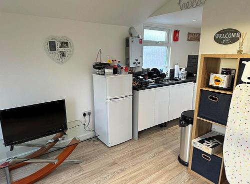 a kitchen with a white refrigerator and a counter top at Sheepy village Leysdown in Leysdown-on-Sea