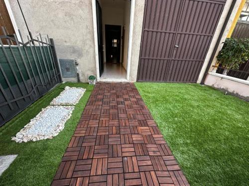 a garden with a brick pathway in the grass at Civico 56 in Verona