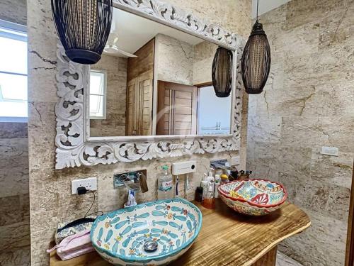 a bathroom with a sink and a mirror at Blue Bay Villa in Haad Yao