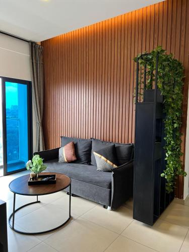 a living room with a couch and a table at Reizz Residence By Sweet Home in Kuala Lumpur