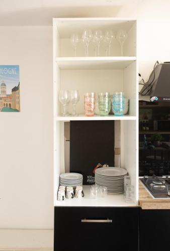 a shelf with glasses and plates in a cabinet at ++++ CENTRAL DUPLEX RENOVE 5 PIECES 150M2 A 8 MN DE LA PLACE DALTON ++++ in Boulogne-sur-Mer