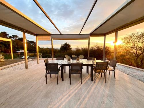 a dining area with a table and chairs on a deck at Aya House in Barcelona
