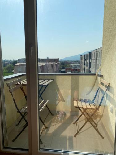 two chairs sitting on a balcony with a view at Love birds place in Skopje