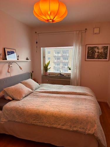 a bedroom with a large bed and a window at Eurovision apartment in central Malmö in Malmö