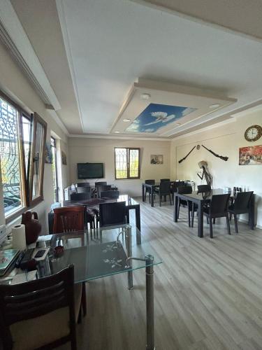 a dining room with tables and chairs and a tv at Sumgayit apart in Cayeli