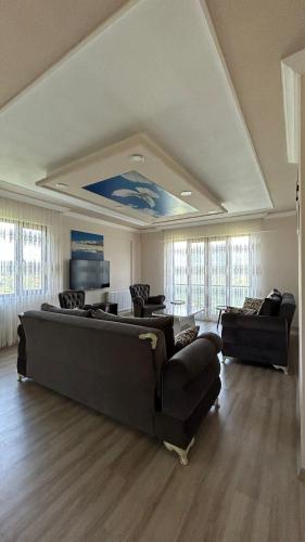a large living room with a couch and couches at Sumgayit apart in Cayeli