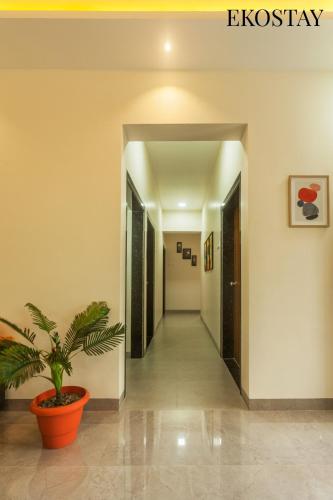 a hallway in a building with a plant in a pot at EKOSTAY - Forestwood Villa in Alibaug