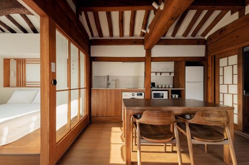 a kitchen with a table and chairs in a room at Luxury hanok with private bathtub -SN15 in Seoul