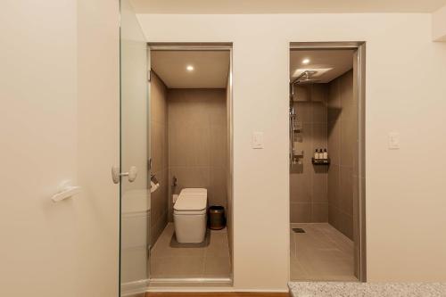 a bathroom with a toilet and a walk in shower at Luxury hanok with private bathtub -SN15 in Seoul