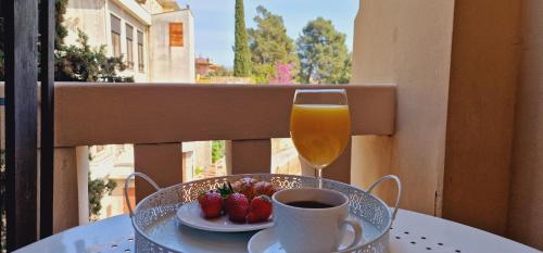 a glass of wine and a plate of strawberries on a table at Apartment Medea 2 with private parking in Opatija