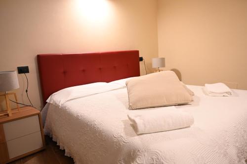 a bedroom with a bed with two pillows on it at Locanda Fermento in Mochignano