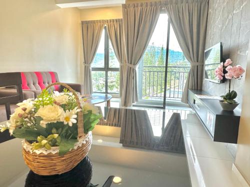 a living room with a basket of flowers on a table at Themework Homestay@Cameron Highlands in Cameron Highlands