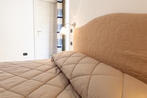 a bedroom with a large bed with a large headboard at B&B Dimora di Girgenti in Agrigento