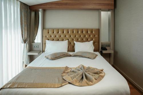 a bed with two pillows and a star on it at Enerji Otel in Ankara