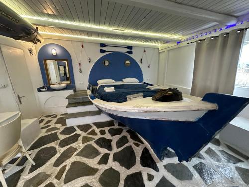 a bedroom with a bed with a fish on it at Naval Hotel Aegina in Egina