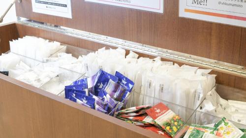 a shelf full of white bags in a store at Vessel Hotel Kumamoto Airport in Ozu