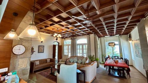 a living room with a couch and a table at The Magnolia Lodge in Almora