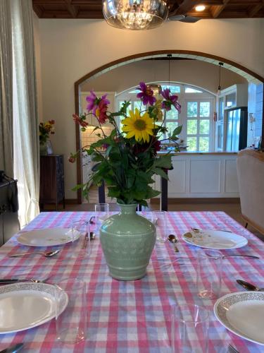 a vase filled with flowers sitting on a table at The Magnolia Lodge in Almora
