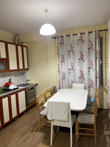 a kitchen with a table and chairs in a room at Durres, Golem, Grand Apartament in Golem