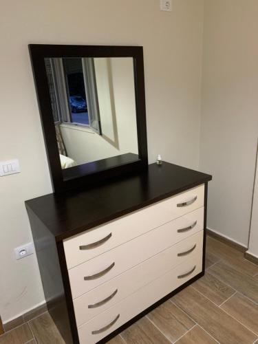 a dresser with a mirror on top of it at Durres, Golem, Grand Apartament in Golem