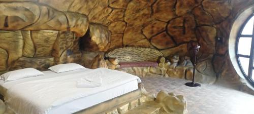 a bedroom with a bed in a log cabin at The River Park Resort in Jagdalpur