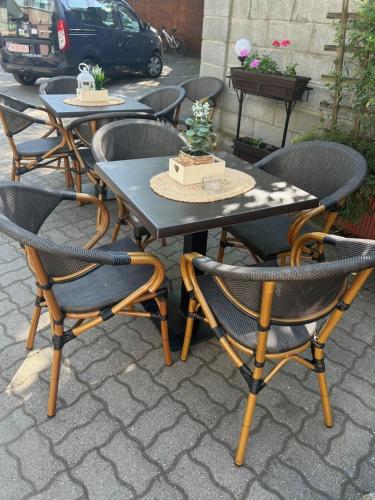 a table with four chairs and a cake on it at Hotel Pacific in Timişoara