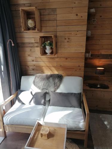 a living room with a couch and a table at Au Coin Fleuri in Malmedy