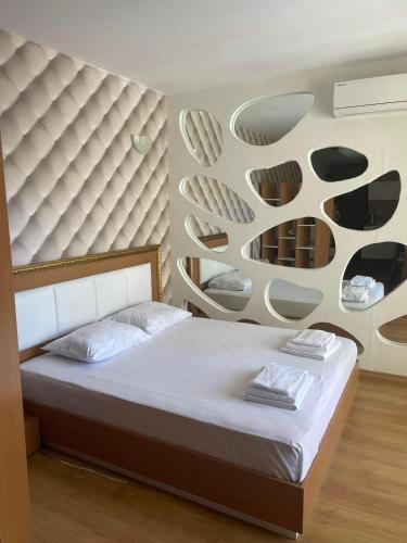 a bedroom with a bed with a wall with shelves at Sweety SP apartments in Sunny Beach