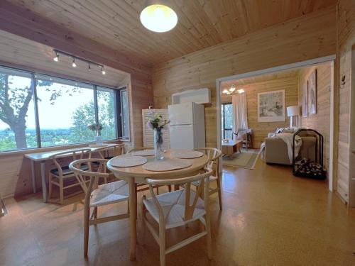 a kitchen and dining room with a table and chairs at Daylesford Unique Stylish 1B1B cottage in Daylesford