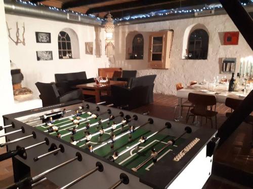 a large chessboard in a room with a table and chairs at Glædegården -Glaede Landhof- 12 beds! in Frøstrup
