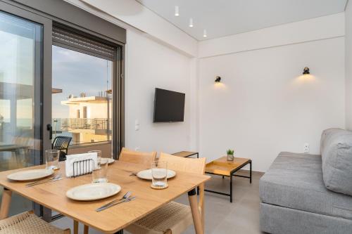 a living room with a table and a couch at Dreta Suites in Chania Town