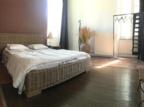 a bedroom with a large bed and a window at La Cigaline in Laure-Minervois