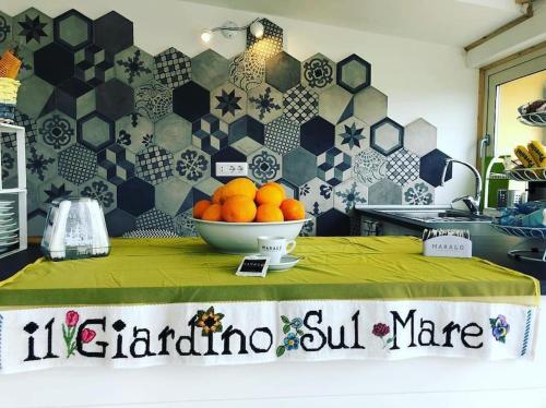 a bowl of oranges on a table in a kitchen at B & B Il Giardino sul Mare in Briatico