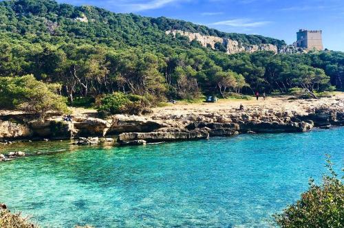 a body of water with a beach and a mountain at Casa Vacanze Momò a Nardò in Nardò
