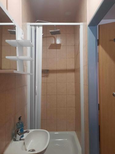 a bathroom with a sink and a shower and a tub at Penzion Avena in Stříbro