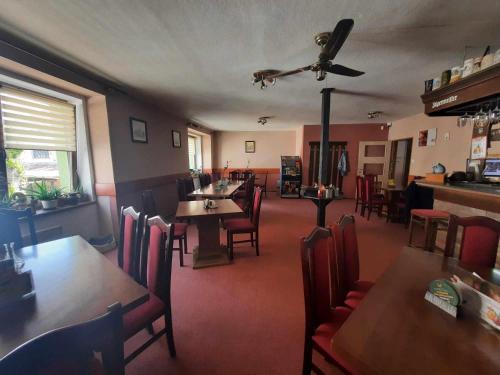 a dining room with tables and chairs and a restaurant at Penzion Avena in Stříbro