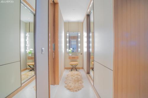 a hallway with mirrors and a rug at Downtown Address Opera, Full Burj & Fountain view 5 Star 3 Bedroom by Gardenia Suites in Dubai