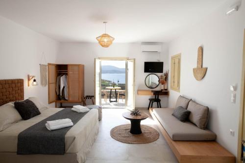a living room with a bed and a couch at Agathia Resort in Schinoussa