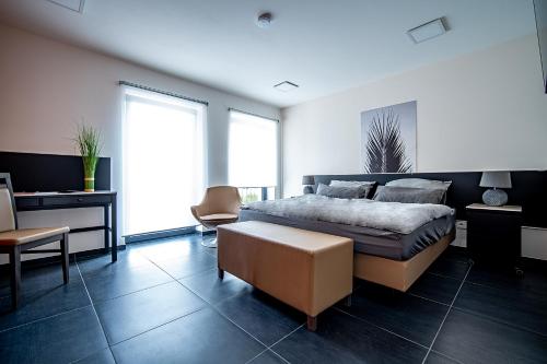 a bedroom with a bed and a desk and a chair at Blauer Stein 7a WH04 - Apartment 2 SZ, 5 Betten in Pulheim