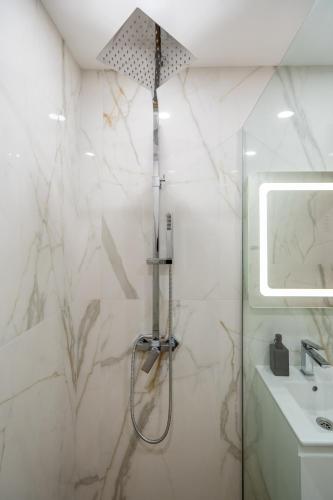 a bathroom with a shower and a sink at Harmony Suite in Sofia